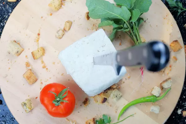 Cheese and tomato on wooden background (Flip 2019)