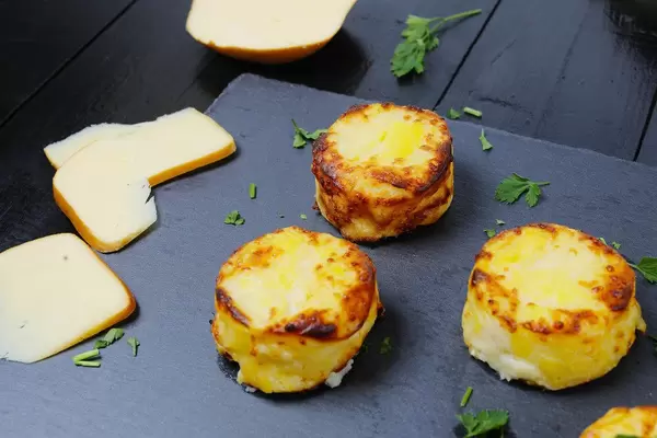 Cheesy potatoes on black background