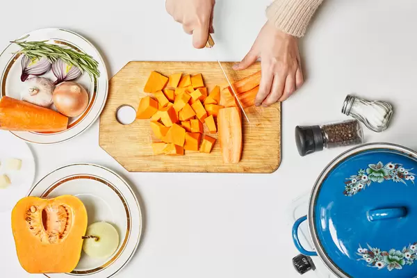 Chef chopping ingredients for pumpkin soup