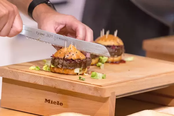 Chef cutting a hamburger