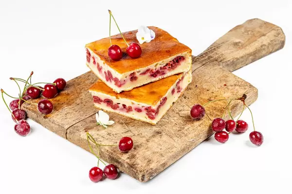 Cherry pie slices on a wooden kitchen Board with fresh cherries (Flip 2020)