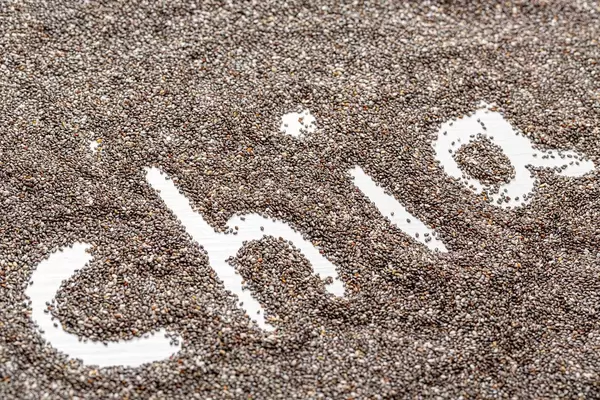 Chia word made on chia seeds background