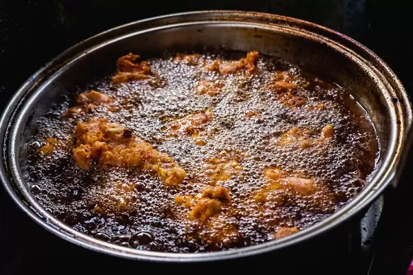 Chicken being cooked in a deep fry pot (Flip 2019)