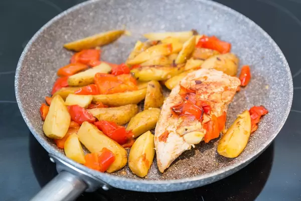 Chicken breast with potatoes and peppers in a pan