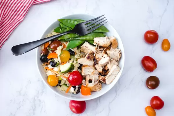 Chicken in a Bowl with Salad and Snow Pea Top View