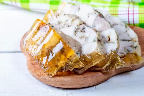 Chicken meat in spicy jelly on the kitchen Board