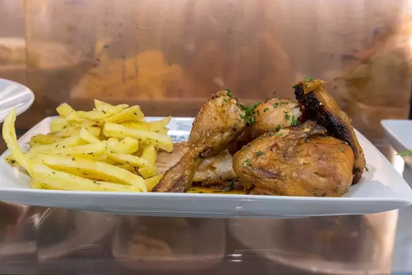 Chicken wings with french fries in portuguese style