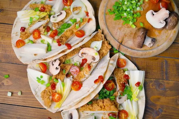 Chicken wrap on wooden background