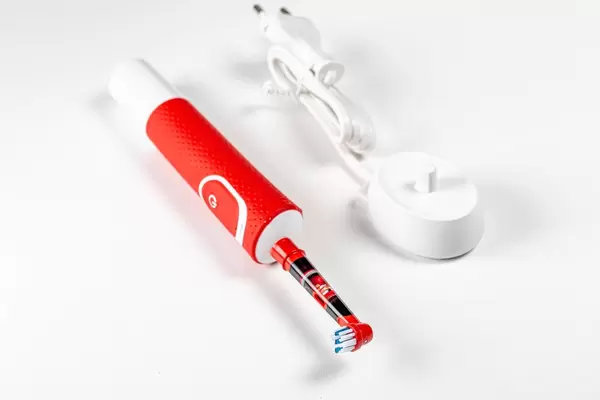 Children's electric toothbrush with charger on a white background (Flip 2020)