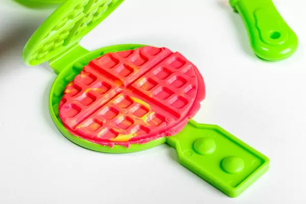 Children's toy waffle iron and plasticine