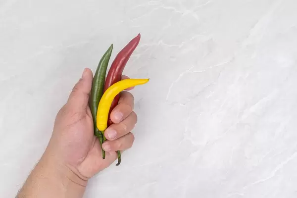 Chilli Peppers in the hand above table