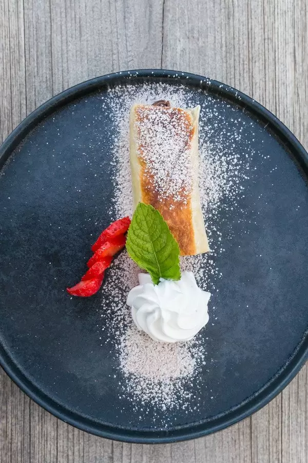 Chimichanga, top view: fried tortilla filled with chocolate and strawberry. Vegan Mexican dessert