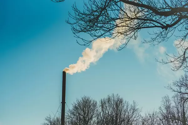 chimney and smoke with blue sky