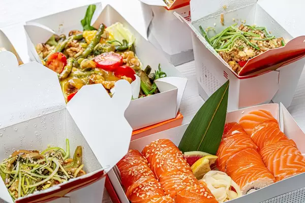 Chinese food in cardboard boxes-salad, sushi, noodles, rice (Flip 2019)