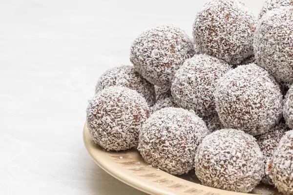 Chocolate Balls with Coconut on the plate with copy space