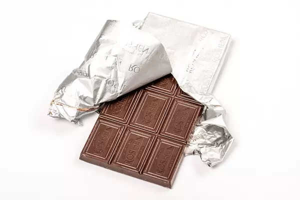 Chocolate bar with foil on white