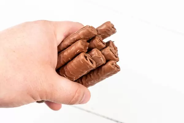Chocolate Bars in the hand above white background