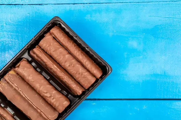 Chocolate Bars on the blue wooden table (Flip 2020)