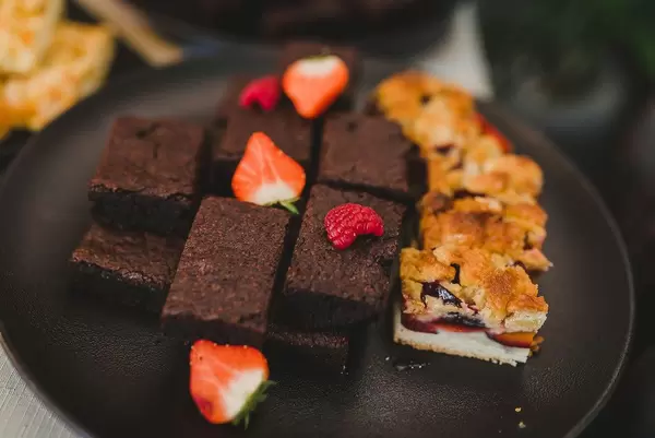Chocolate Brownie With Berries On Black Plate