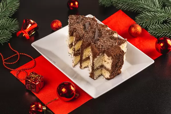 Chocolate cake in shape of Christmas tree with red decor