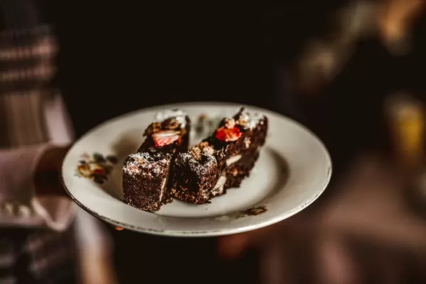 Chocolate Cake With Nuts And Strawberries On Ceramic Vintage Plate
