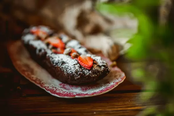 Chocolate Cake With Nuts And Strawberries On Vintage Plate