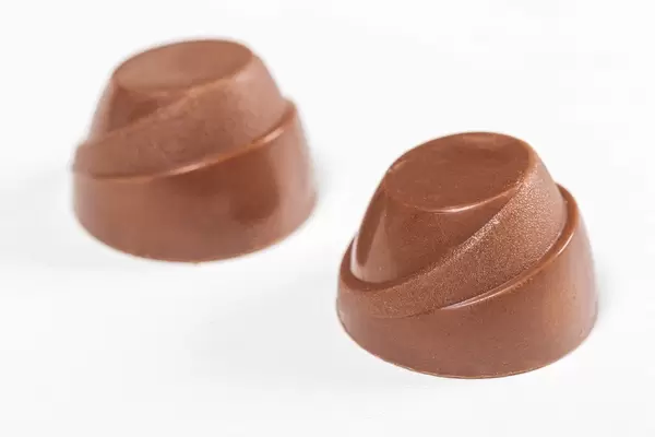 Chocolate candies on white background close up