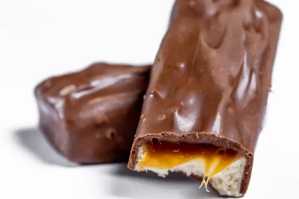 Chocolate candy with caramel and nougat inside