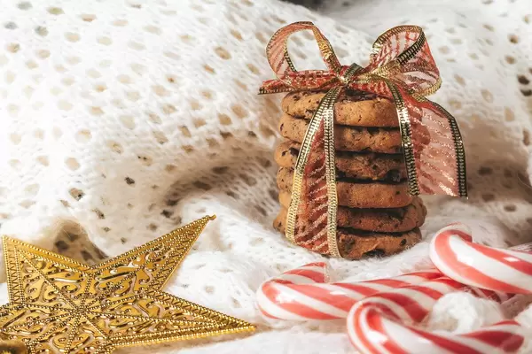 Chocolate chip cookies with Lollipop cane on white knitted background (Flip 2019)