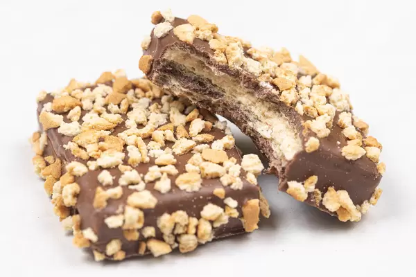 Chocolate Cookies with grated Hazelnuts above white background
