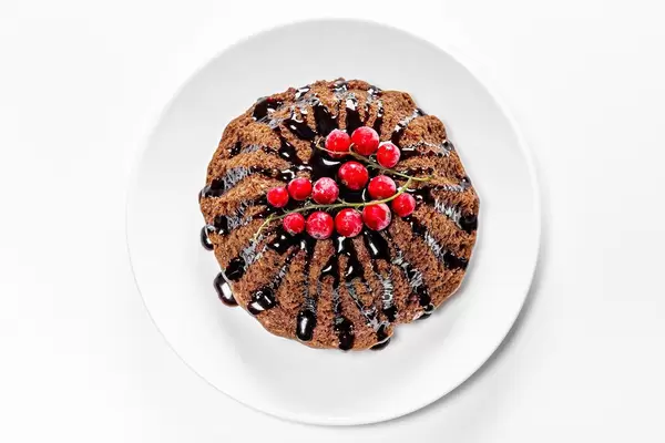 Chocolate cupcake with red currants and chocolate topping. The view from the top (Flip 2019)