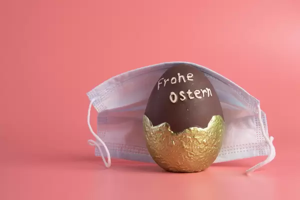 Chocolate easter egg covered with medical face mask