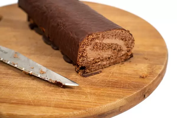 Chocolate Roll cake sliced on the wooden board (Flip 2020)