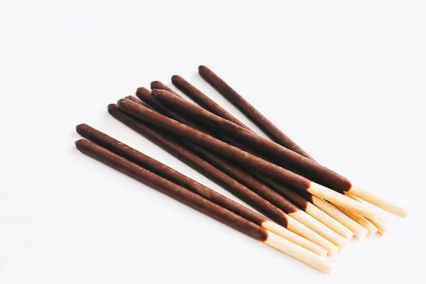 Chocolate sticks on white background. Crackers.
