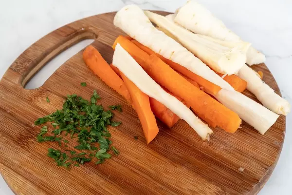 Chopped Carrot and Parsnip on the cutting wooden table (Flip 2019)