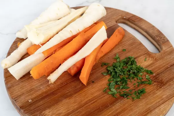 Chopped Carrot and Parsnip on the cutting wooden table