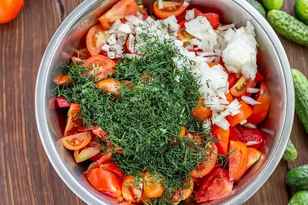 Chopped fresh vegetables and herbs for making summer vegetarian salad