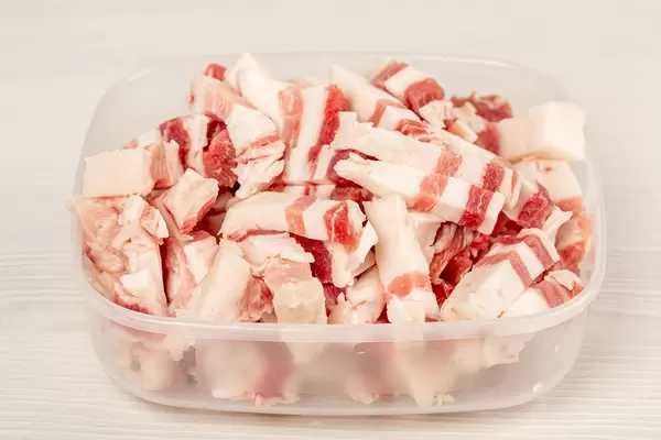 Chopped pieces of lard in a plastic container
