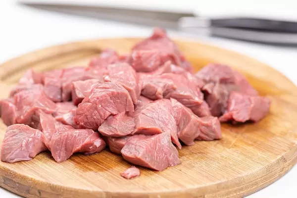 Chopped raw Beef meat on the wooden cutting board