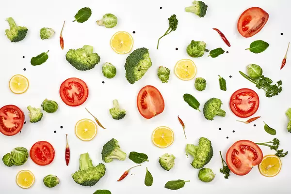 Chopped raw vegetables and fruits background