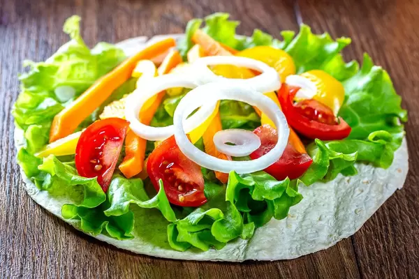 Chopped vegetables and lettuce on pita