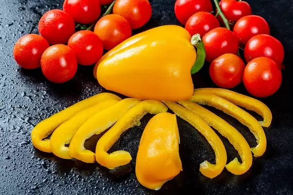 Chopped yellow pepper with branches of cherry tomatoes