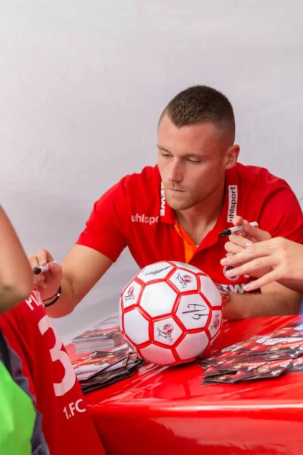 Christian Clemens signiert das Trikot eines Fans