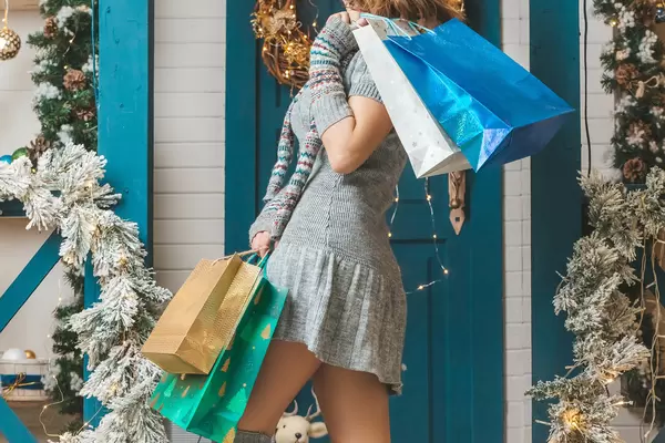 Christmas background girl with lots of shopping