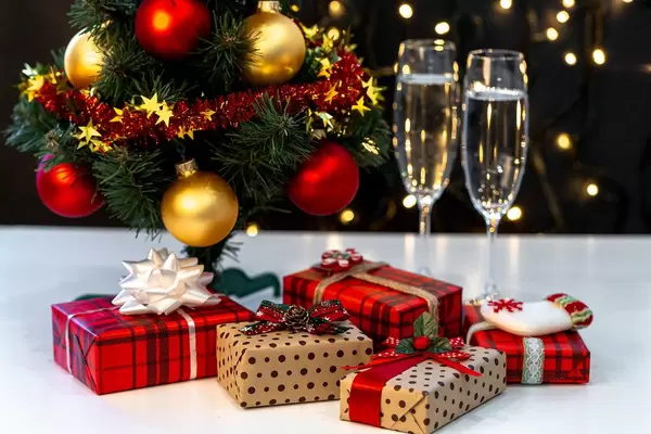 Christmas background with Christmas tree, gifts and glasses of champagne (Flip 2019)