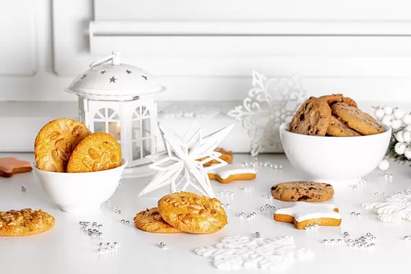 Christmas background with different cookies, decor and lantern with burning candles (Flip 2019)