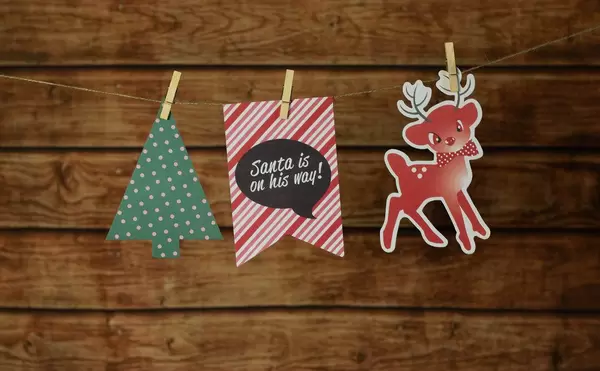 Christmas background with traditional decorations hanging on a rope