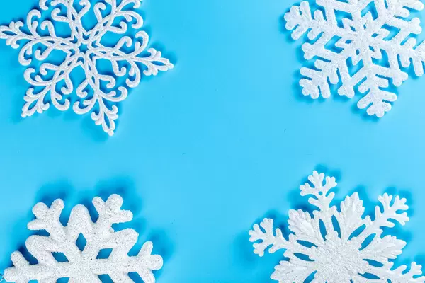 Christmas background with white snowflakes on blue