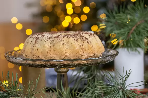 Christmas cake with branch xmas tree and golden bokeh