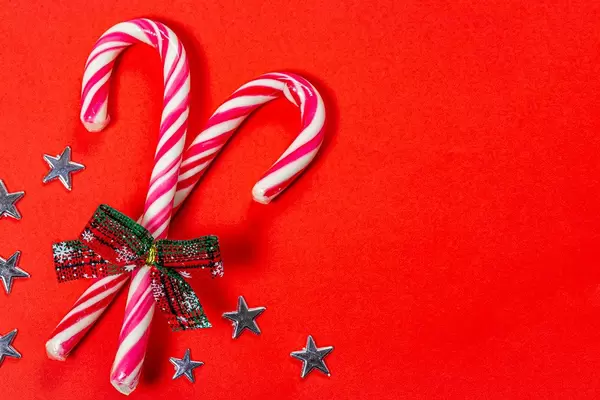 Christmas candy canes on a red background with stars (Flip 2019)